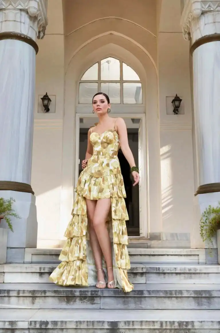 Frau mit elegantem gelben vor einer Treppe